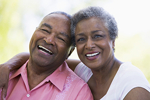 couple smiling and laughing with their heads pressed against each other